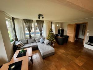 a living room with a couch and a christmas tree at Charmantes Ferienhaus an der Mosel in Ediger-Eller