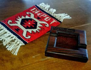 a rug and a book on a wooden table at Hotel style rooms & restaurant Pirocanac in Pirot