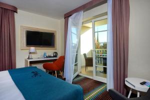 a hotel room with a bed and a balcony at Stay inn Hotel Gdańsk in Gdańsk