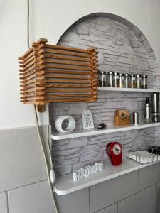a bathroom with a stone wall with a shower head at Genex 37 in Novi Beograd