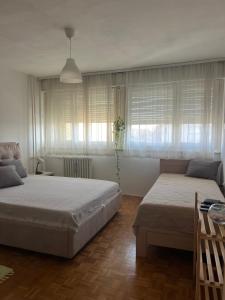a bedroom with two beds and a window at Genex 37 in Novi Beograd