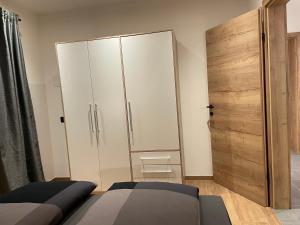 萊奧岡的住宿－Appartement Bergsicht，一间卧室设有大衣柜和一张床