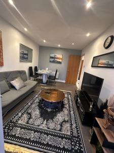 a living room with a couch and a table at Cozzy Stay in London