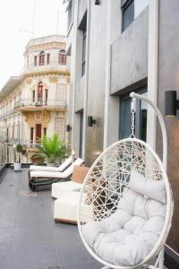 a swinging chair on the balcony of a building at Hotel de Turistas Iquitos in Iquitos