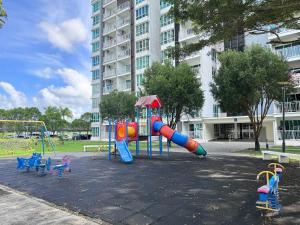 a playground in a park with a large building at Sandakan IJM condo full-equipped homestay in Sandakan