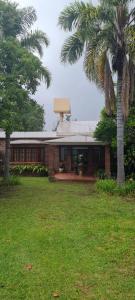 a brick house with a palm tree in a yard at Casa MOVA in San Lorenzo