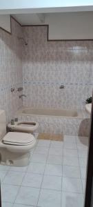 a bathroom with a toilet and a bath tub at Casa MOVA in San Lorenzo