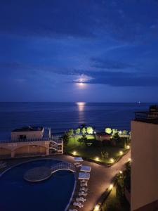 a view of the ocean from a hotel at night at Grand Midia Resort, Sky level apartments in Aheloy
