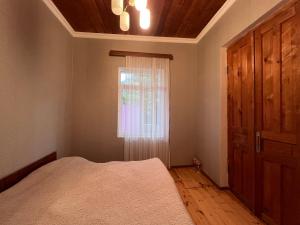 an empty bedroom with a bed and a window at Home Inn Samegrelo in Kheta +24 photos