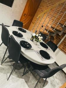 a white table with black chairs around it at BRIVIBAS RESIDENCE - STONES, free PRIVAT parking, free WIFI, self check-in in Rīga