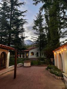 a house with a courtyard with lights and trees at El Torreón Lodge in Potrerillos