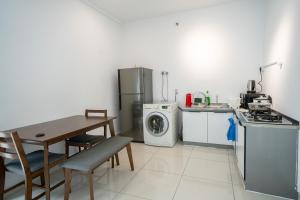 a kitchen with a table and a stove and a refrigerator at Seaview Mansion One Georgetown in George Town