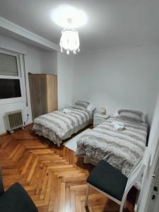 a bedroom with two beds and a chandelier at Vintage House in Vigo