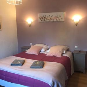 a bedroom with two beds with towels on them at la forge de Clermont in Clermont