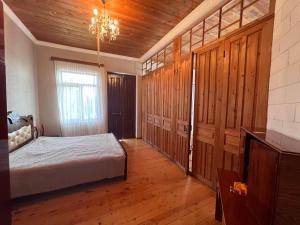 a bedroom with a bed and a wooden ceiling at Home Inn Samegrelo in Kheta