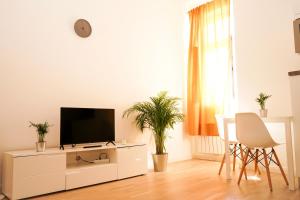 a living room with a tv on a white cabinet at Centrally Located Gem in Prague in Prague