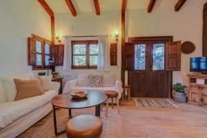 a living room with a couch and a table at La cabaña del Burguillo in El Barraco