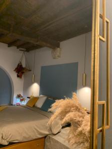 a bedroom with a bed with a blue headboard at La corte di Frascati in Frascati