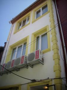 a yellow and white building with two windows at Bereket traveler Hotel in Istanbul
