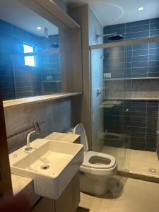a bathroom with a toilet and a sink and a shower at Eco resort praia de carneiros in Praia dos Carneiros