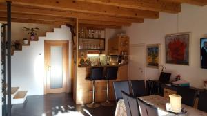 a room with a table and chairs and a staircase at Il Fienile in Tremosine Sul Garda