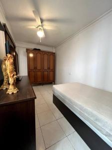a bedroom with a bed and a table with a cat statue at Casa Martín Playa in Málaga