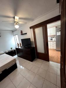 a large room with a bed and a kitchen at Casa Martín Playa in Málaga