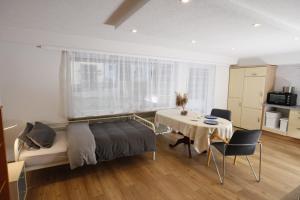 a bedroom with a bed and a table and a kitchen at Appartment mit Parkplatz in Würzburg