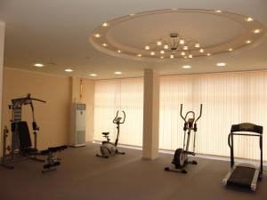 a gym with several treadmills and exercise bikes in a room at Apart Hotel Happy in Sunny Beach