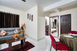 a living room with a couch and a table at AAFIYA LAKEVIEW APARTMENTS in Coimbatore