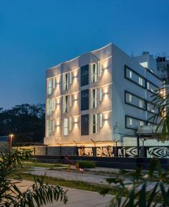 a building with lights on the side of it at AAFIYA LAKEVIEW APARTMENTS in Coimbatore