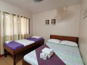 Postel nebo postele na pokoji v ubytování JBR Tourist Inn - Port Barton