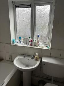 a bathroom with a sink and a toilet and a window at Heywood in Heywood