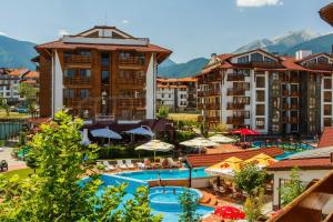 a resort with a swimming pool and some buildings at Апартаменты в Belvedere in Bansko