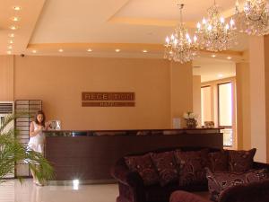 a bride standing at the reception counter in a hotel lobby at Apart Hotel Happy in Sunny Beach