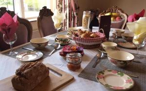 a table with bread and bowls and a basket of food at Glencove in Ennis