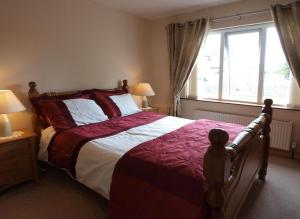 a bedroom with a large bed and a window at Glencove in Ennis