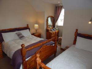 a bedroom with two beds and a mirror at Glencove in Ennis +11 photos