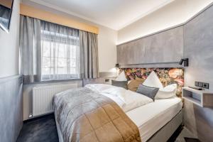 a bedroom with a large bed and a large window at Aliona Apart in Sölden