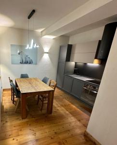 a kitchen and dining room with a table and chairs at MB26 in Courmayeur
