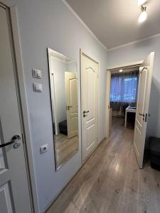 a hallway with two doors and a mirror on the wall at Tallinn's Prime Spot: Pae 49 - Near Airport, Concerts & Shops in Tallinn