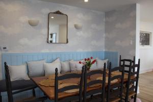 a dining room with a table and a mirror at Queen Suite with Private Ensuite at Fancie's PEC - Suite 1 in Belleville