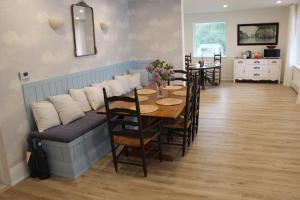 a dining room with a table and a couch at Queen Suite with Private Ensuite at Fancie's PEC - Suite 1 in Belleville