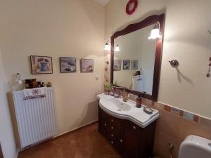 a bathroom with a sink and a mirror at Evenos Stone Villa in Ierapetra +52 photos