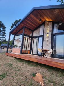 圣本图-杜萨普卡伊Chalés Bergview的房屋前设有窗户和桌子