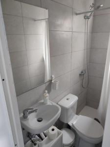 a small bathroom with a toilet and a sink at Playgarza relax in Telde