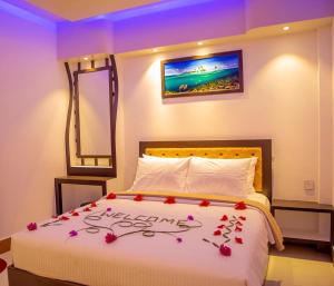 a bedroom with a bed with flowers on it at Sunview Residence in Kaashidhoo