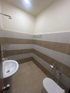 a bathroom with a toilet and a sink at Ruhaneeyat Home Stay in Amritsar