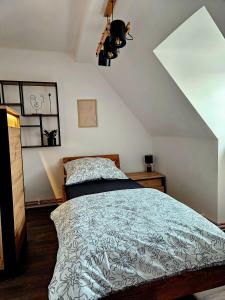 a bedroom with a bed with a black and white comforter at Vila Citadella in Svitavy