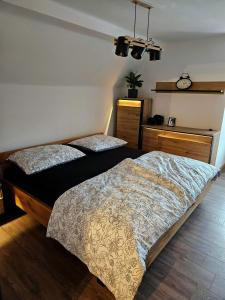 a bedroom with two beds and a clock on the wall at Vila Citadella in Svitavy